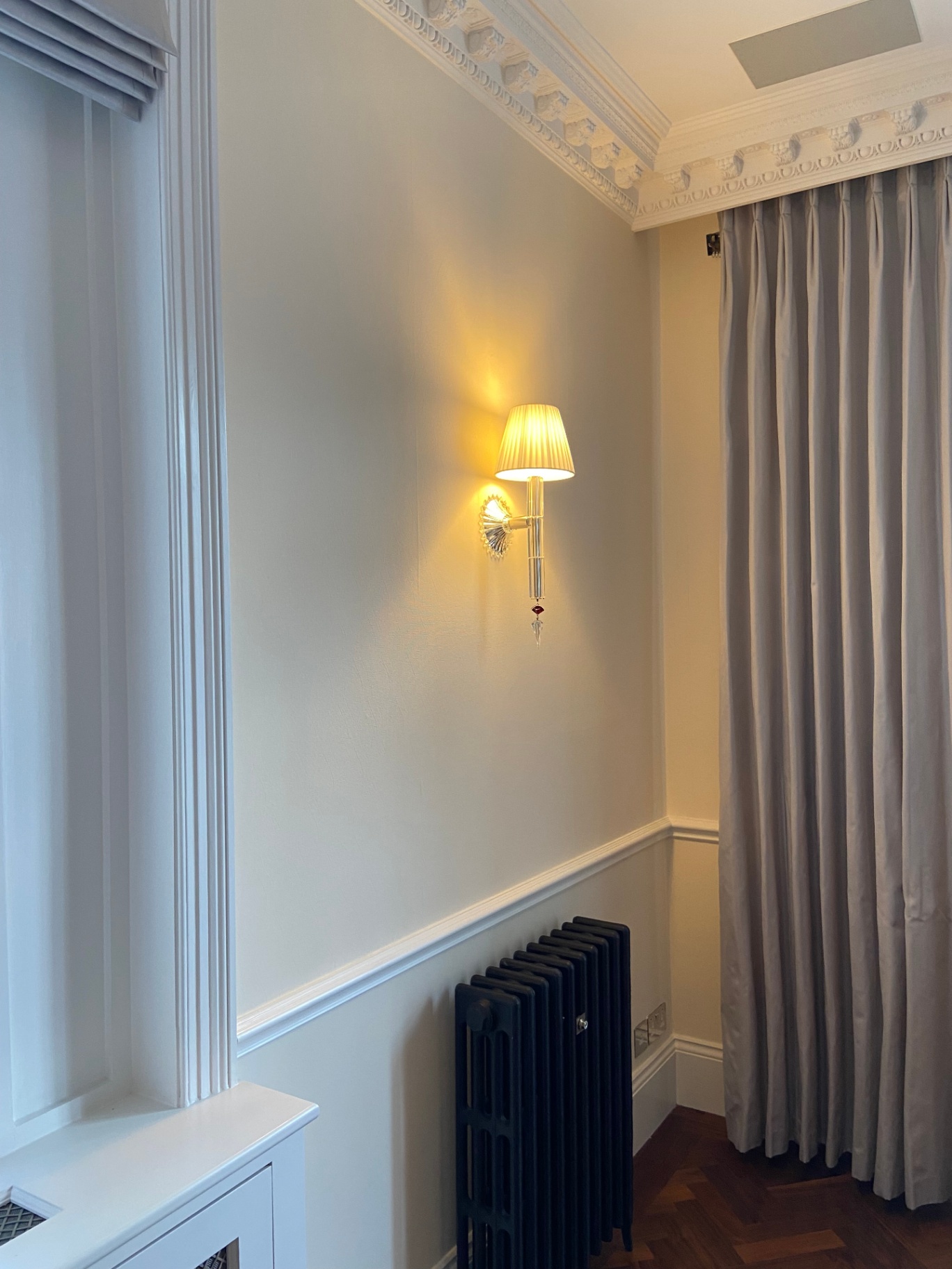 Soft Farrow & Ball Tallow 203 finish behind a crystal wall sconce, cut in cleanly by hand — Belgravia SW1