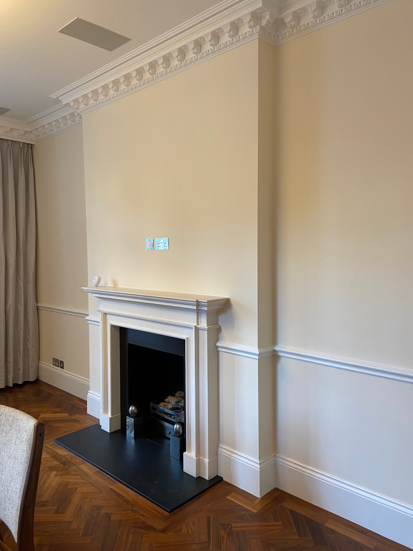 Farrow & Ball Tallow 203 emulsion matt walls framing a stone fireplace with original cornicing in eggshell white — Belgravia drawing room