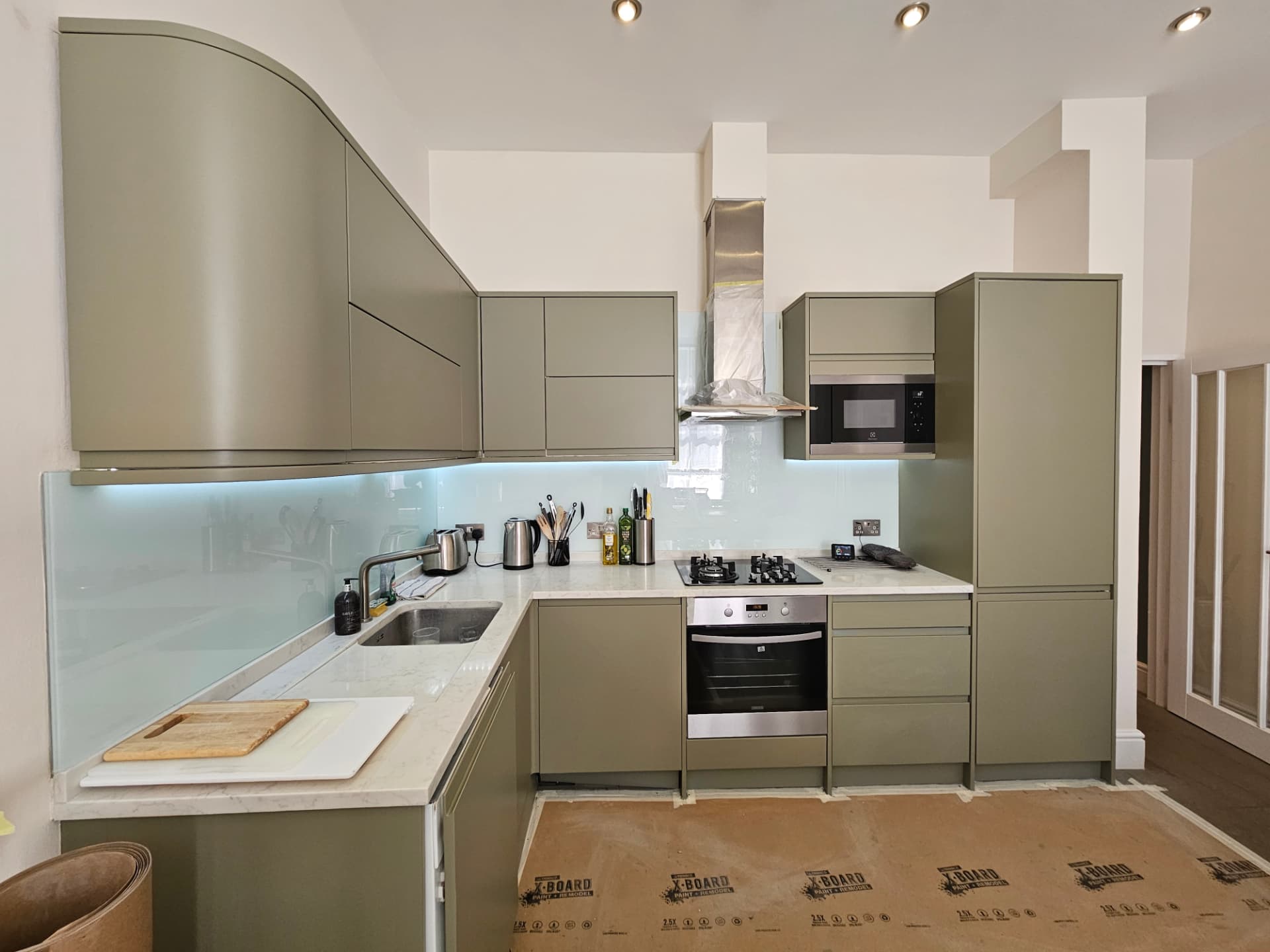 After — Maida Vale kitchen transformation in farrow & ball treron. Hand-finished kitchen respray in a fine low-sheen matt for a factory-flat, hard-wearing finish.