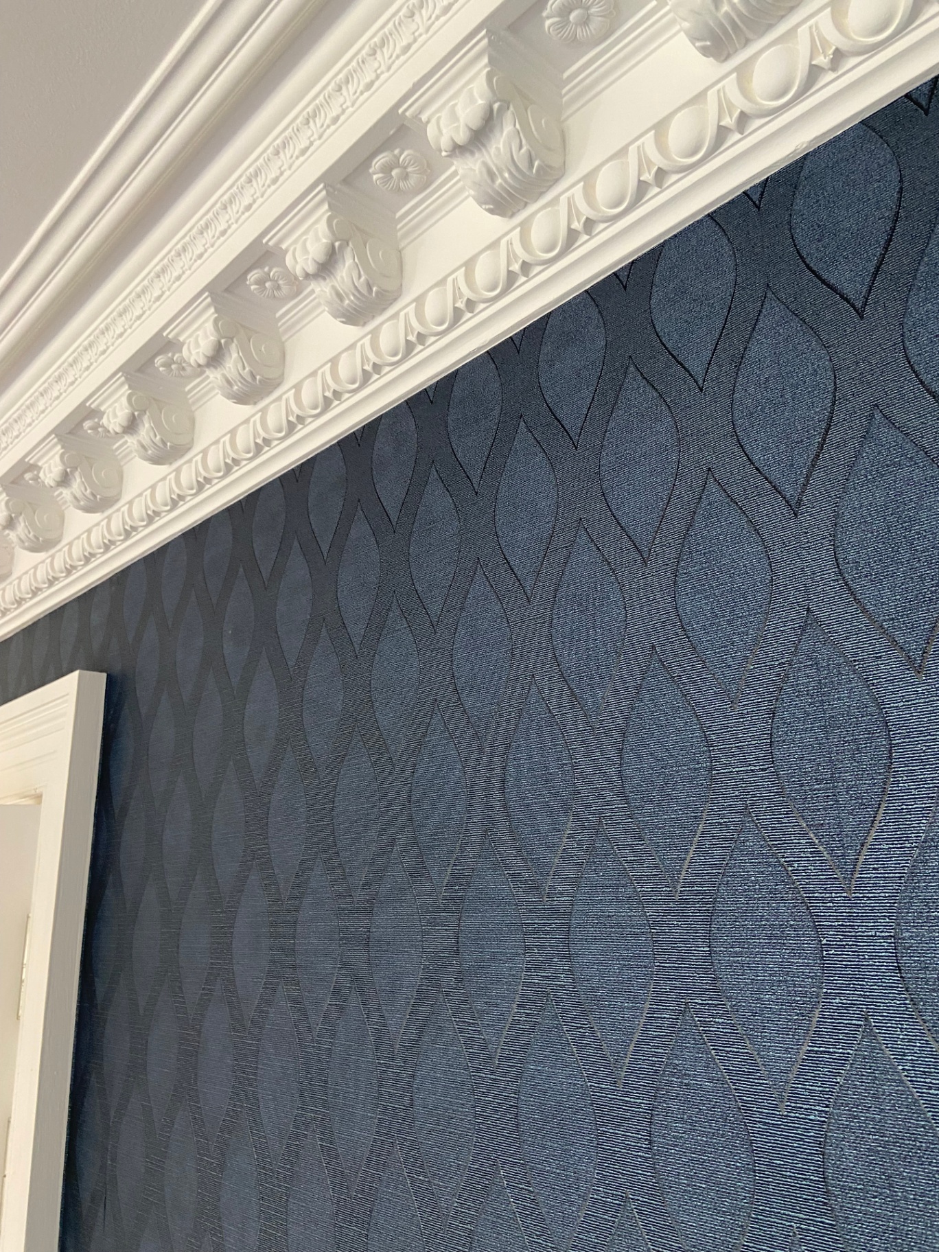 Original Victorian dentil cornicing hand-cut in eggshell white against navy textured wallpaper — Belgravia repaint in progress